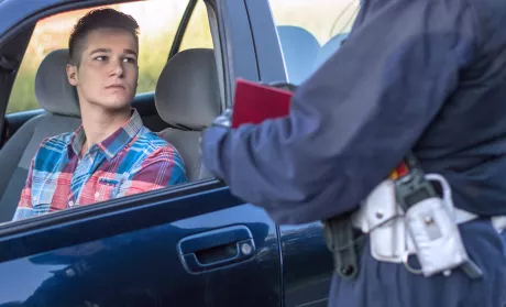 Young man receiving traffic ticket 